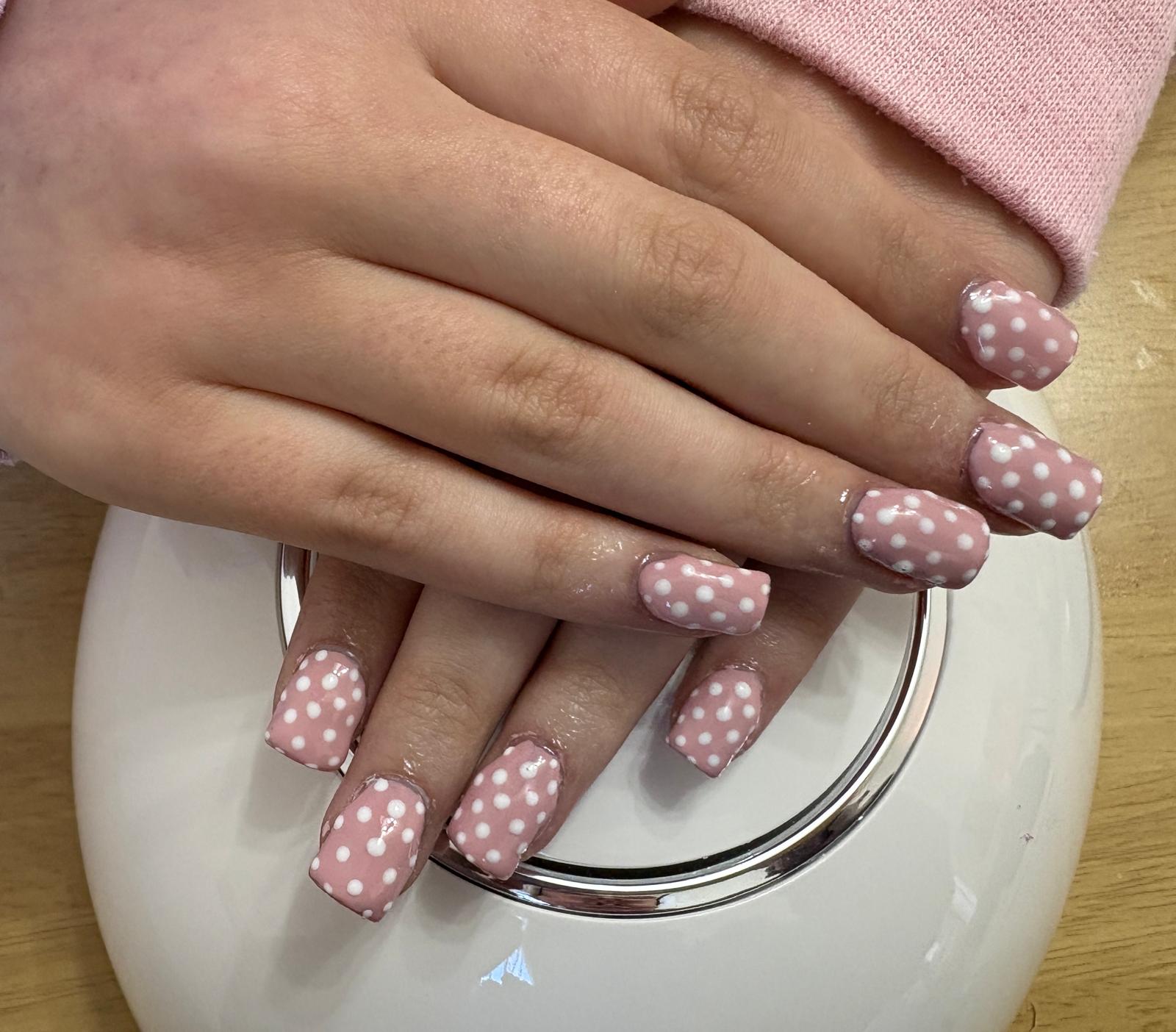 Soft pink polka-dot gel manicure